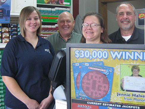 Rock "C" staff members, from left, Tara Stotser, Preston Ault and Jessica Loewen, and Lottery District Sales Representative Kevin Claxton stand behind the counter at the Rock "C" Store in Iowa Falls.